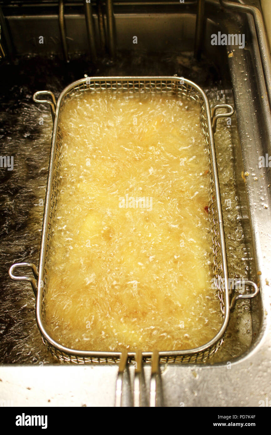 frying chipped potatoes in deep fat fryer Stock Photo Alamy