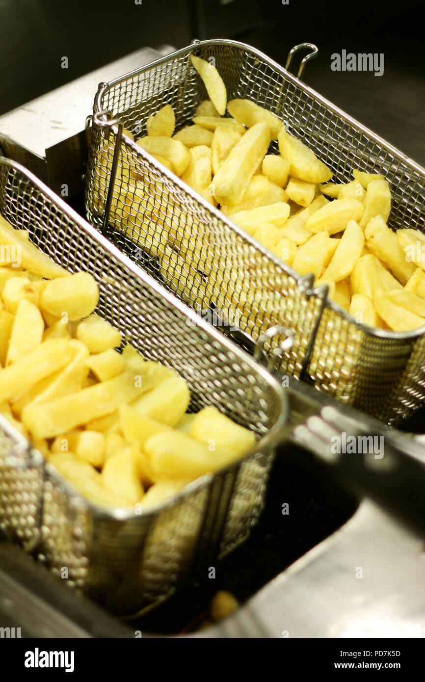 frying chipped potatoes in deep fat fryer Stock Photo Alamy
