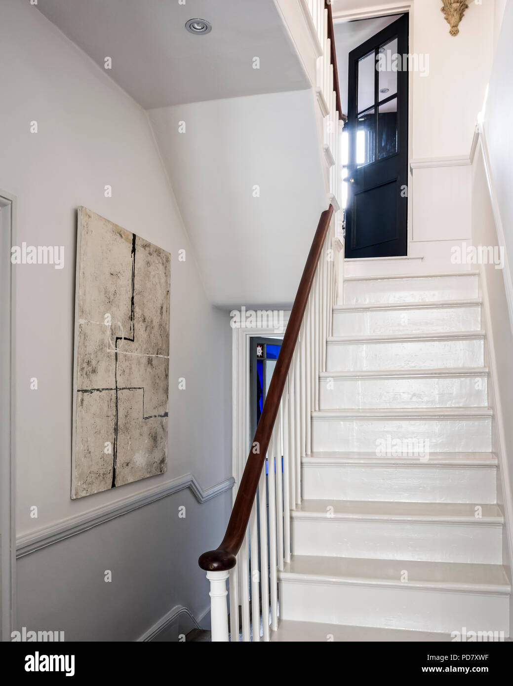 Wooden staircase painted in mid French Grey whilst the walls are Slaked Lime from Little Greene. Stock Photo