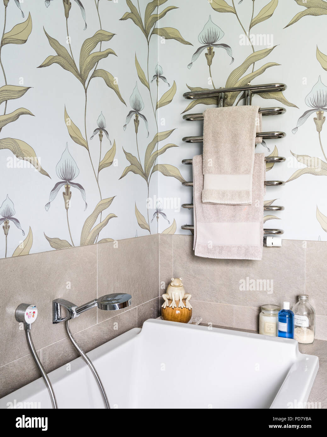 Orchid wallpaper from Cole and Son in bathroom with grey porcelain tiles  from Porcelanosa Stock Photo - Alamy