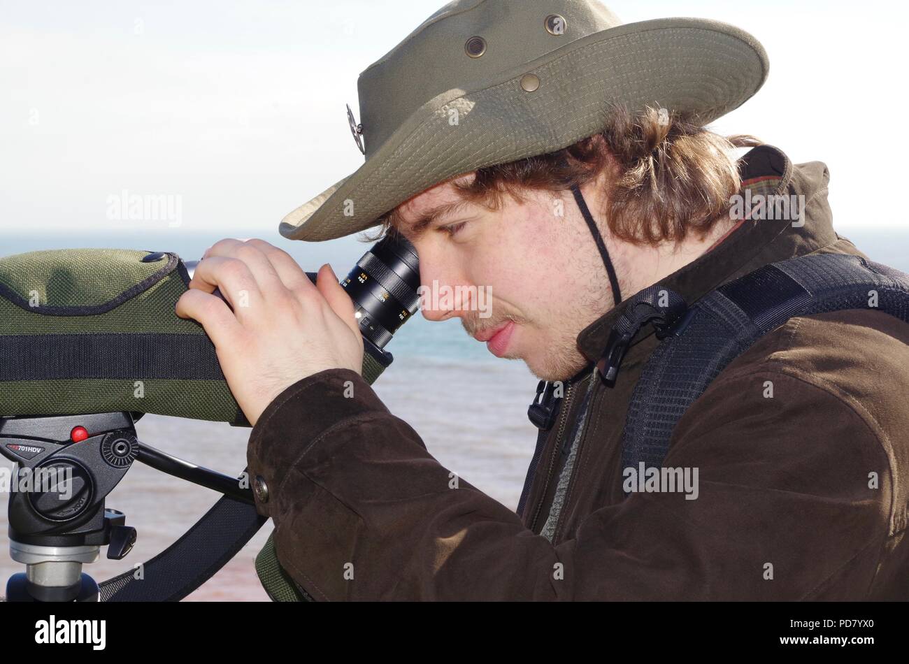 British Birdwatcher with Leica Spotting Scope Birdwatching at Budleigh Salterton on the South