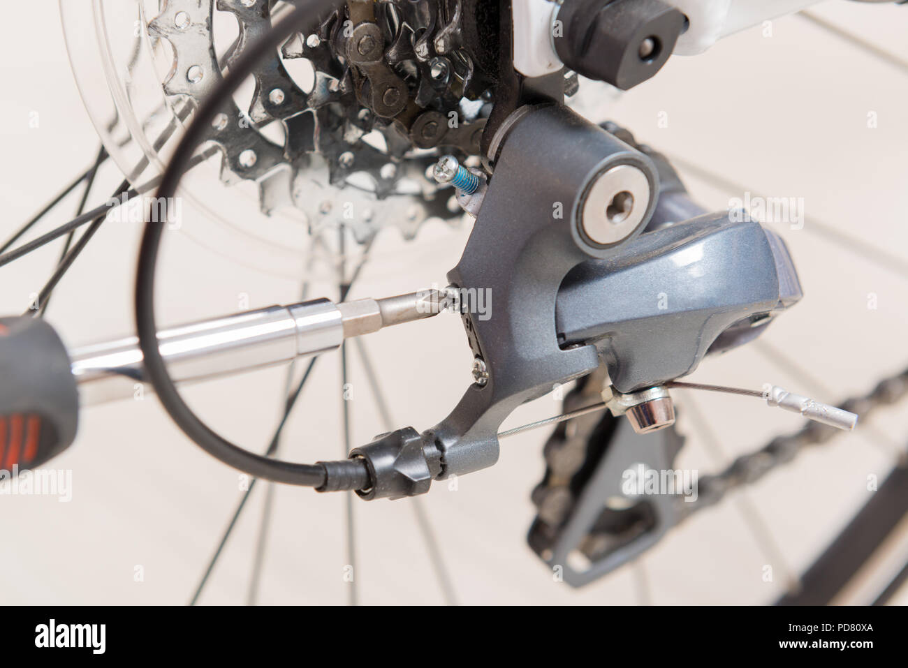 Adjusting bicycle's rear derailleur Stock Photo Alamy