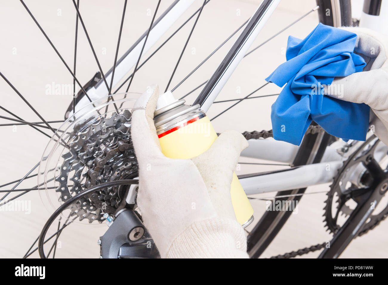 Preparing bicycle for a new season. Hands with cloth and cleaning or