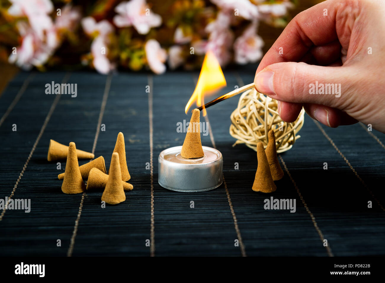 Traditional natural incense cones lighting with maches Stock Photo Alamy