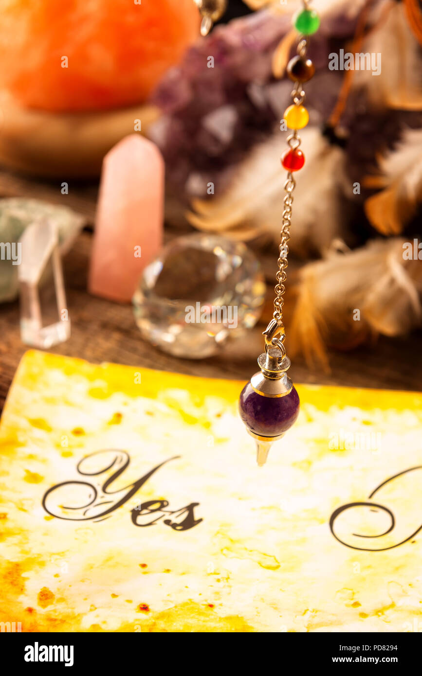 Pendulum, tool for dowsing over yes and no choosing diagram Stock Photo