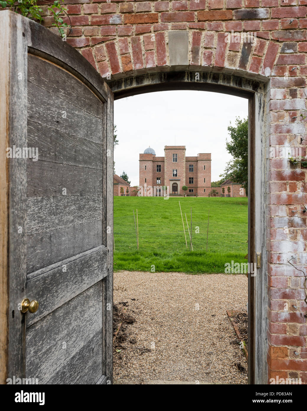 View through wall garden door to exterior facade of Whithurst Park. Stock Photo