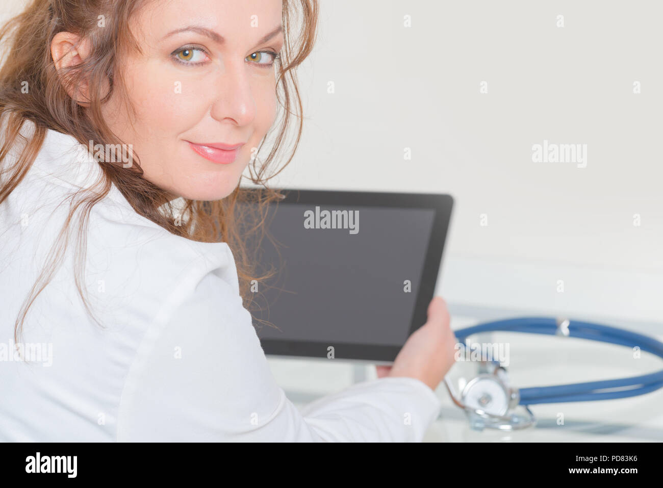 Woman medical doctor using tablet pc at the consulting room Stock Photo