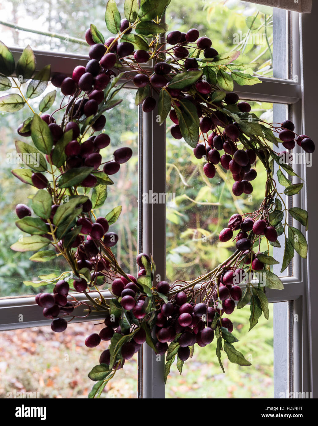 Hand made berry wreath on glass panelled back door Stock Photo