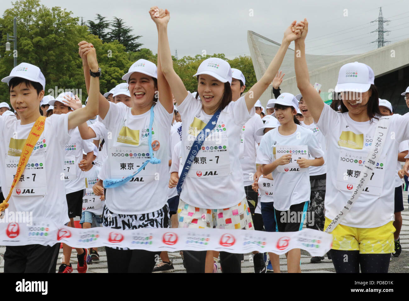 Tokyo, Japan. 7th Aug, 2018. Barcelona Olympics swimming gold medalist Kyoko Iwasaki(R), marathon runner Masako Chiba (2nd R) and TV personality Suzanne (2nd L) cross the finish line for the '1,000km relay to Tokyo' at the Komazawa stadium in Tokyo on Tuesday, August 7, 2018. Some 1,600 runners participated the marathon relay from Aomori to Tokyo for the commemoration of the 3.11 East Japan Great Earthquake. Credit: Yoshio Tsunoda/AFLO/Alamy Live News Stock Photo