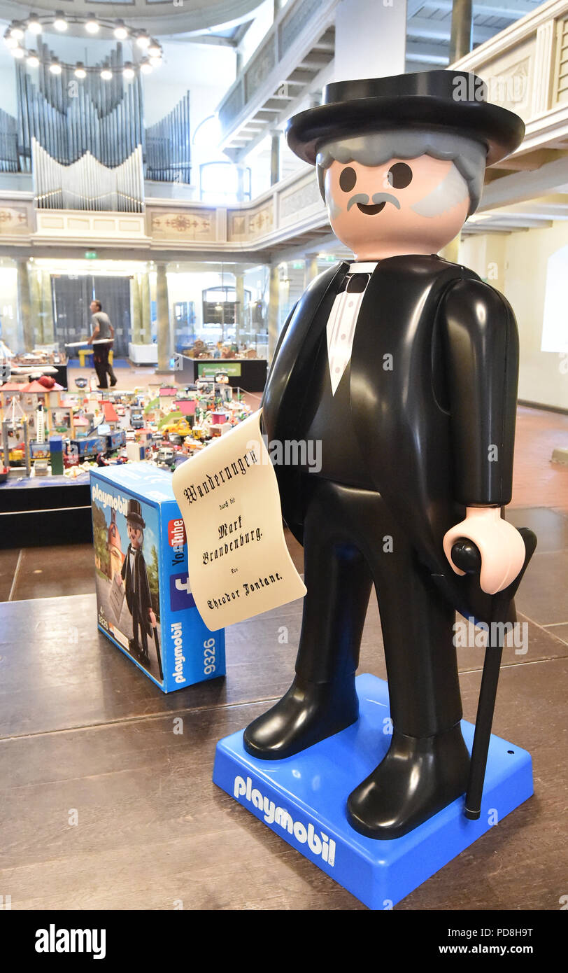 Neuruppin, Germany. 08th Aug, 2018. A large fontane figure stands in the  toy exhibition in the Kulturkirche. Until 9 September, the exhibition shows  worlds with Playmobil figures. A limited edition of the