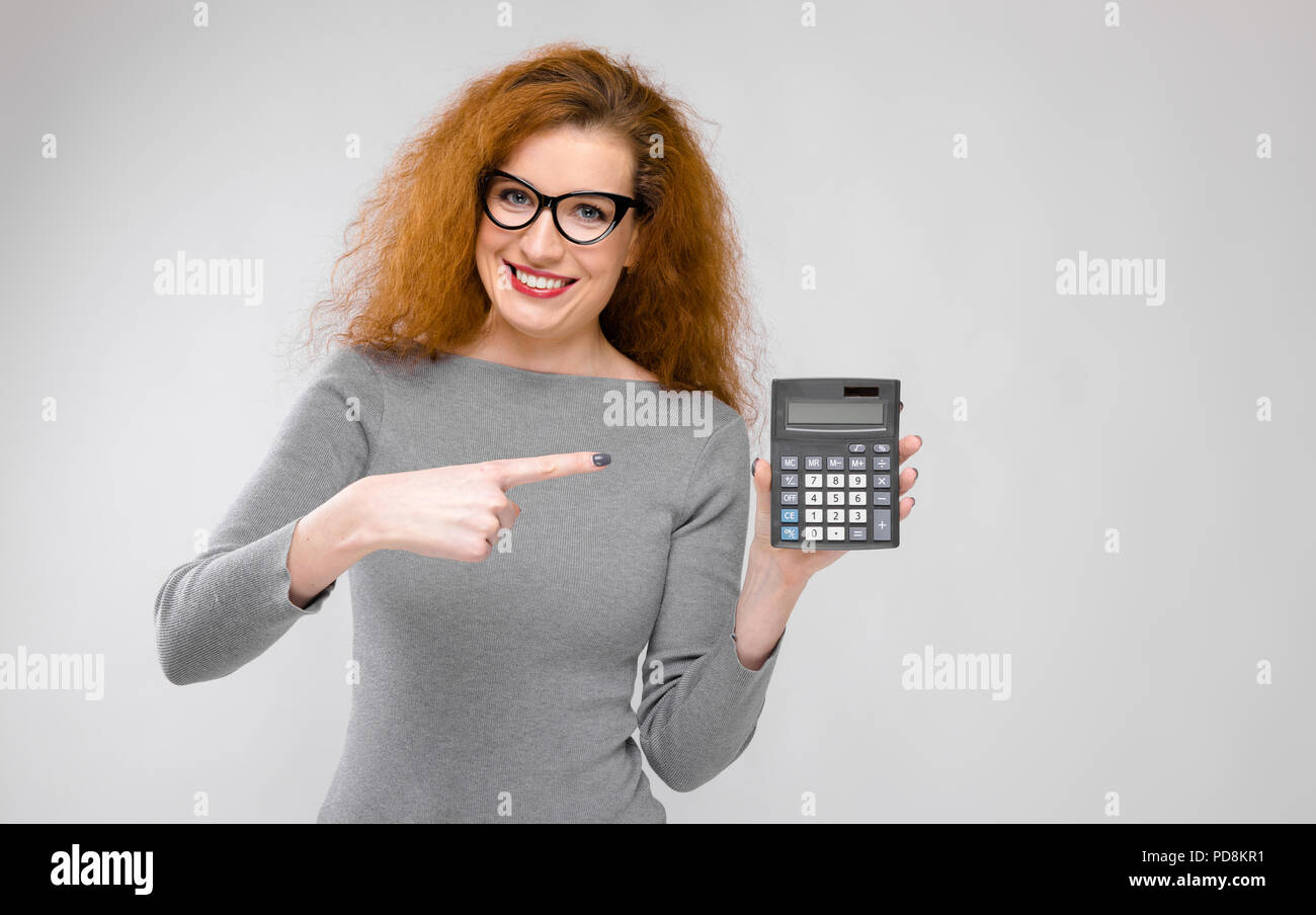 Young woman holding calculator Stock Photo