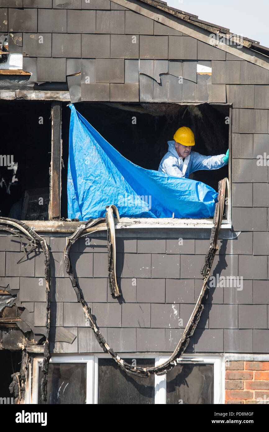 Police and fire investigations officers at the scene of a house fire on