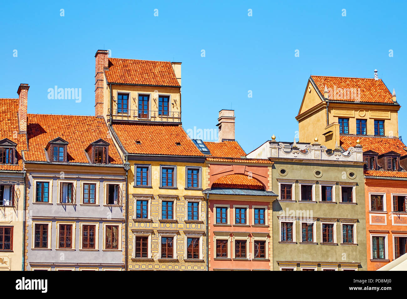 Bright facades of houses with tiled roofs in the historical center of