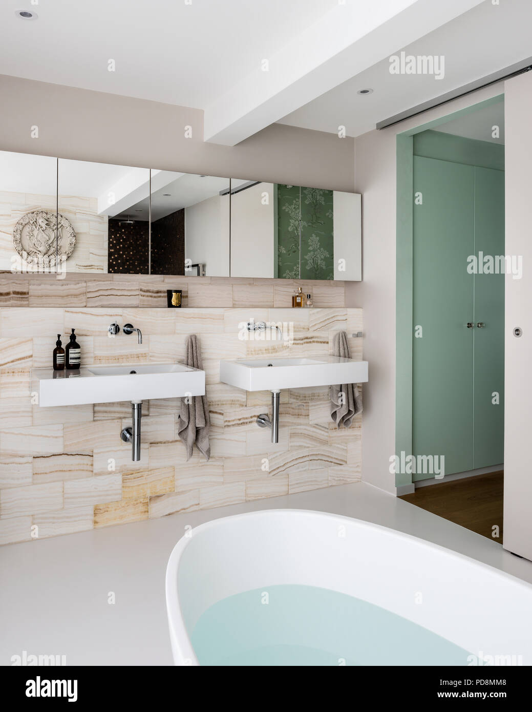 Mirrored cabinets above basins in ensuite bathroom Stock Photo