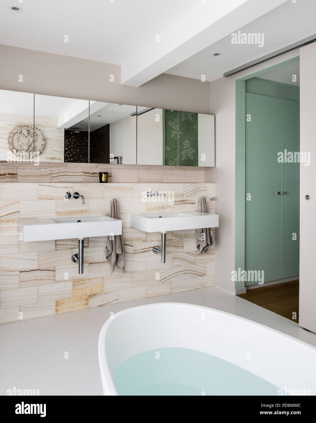 Mirrored cabinets above basins in ensuite bathroom Stock Photo