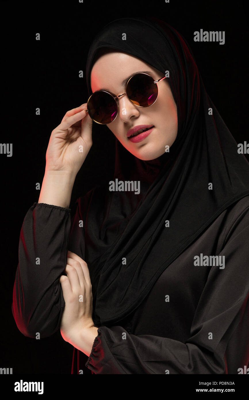 Portrait of beautiful stylish young muslim woman wearing black ...