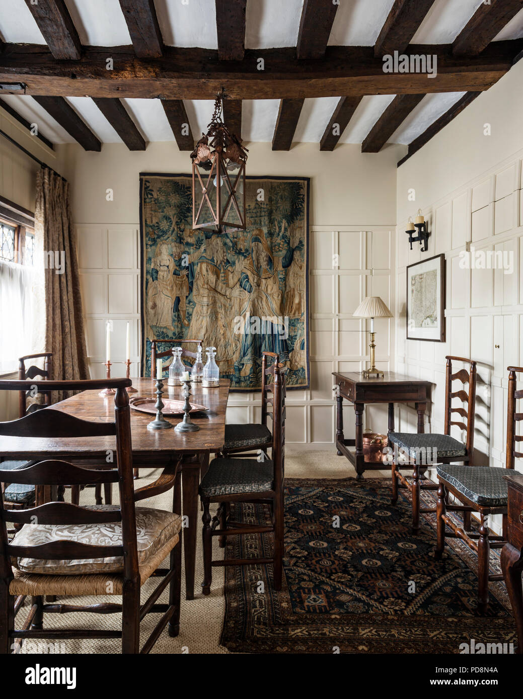 Enlarged dining room of Grade II listed building with wall tapestry Stock Photo
