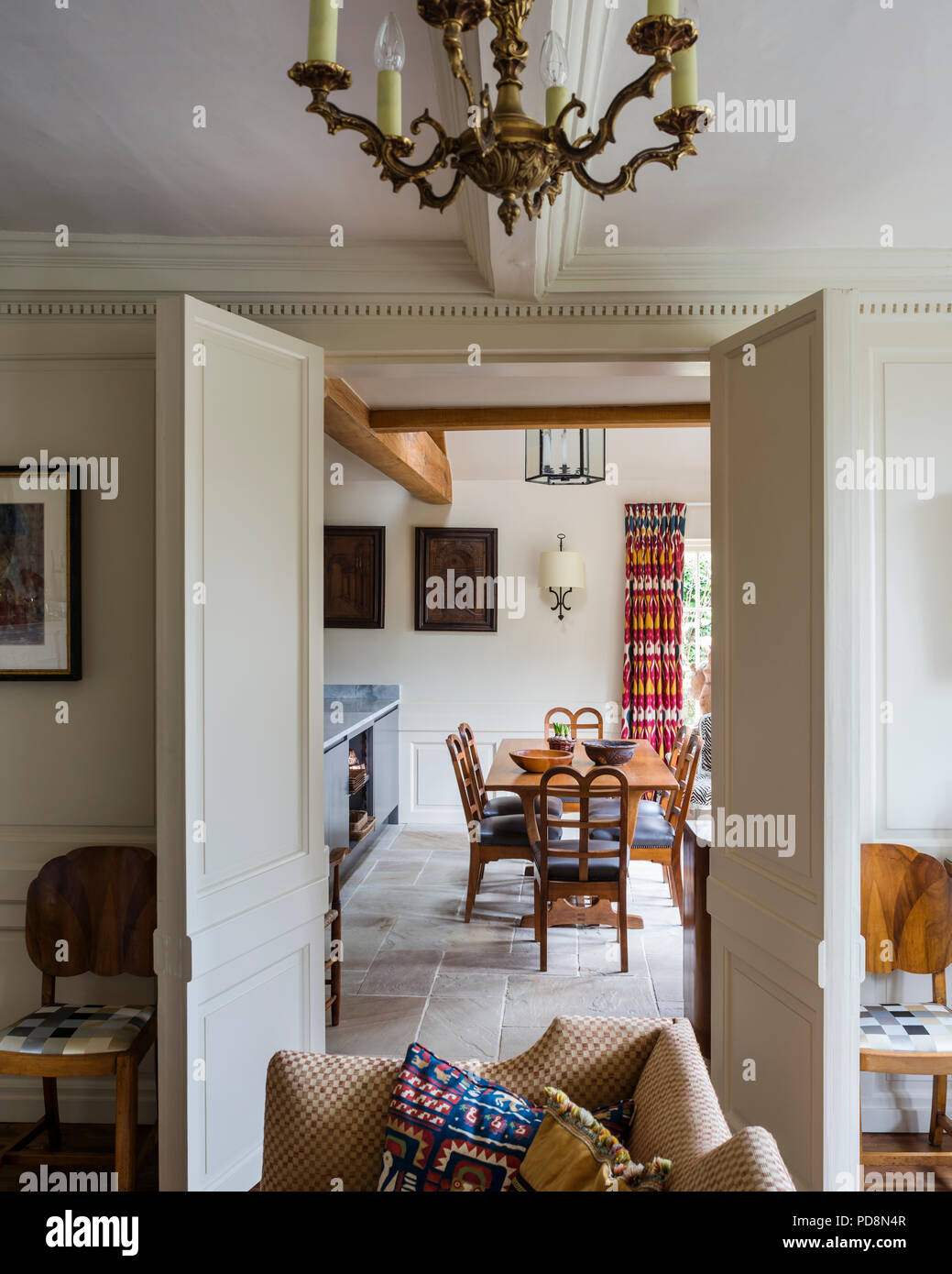 View through double doorway to vintage dining table and chairs Stock Photo