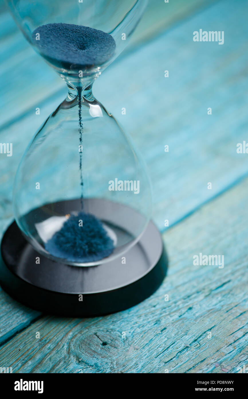 Photo of hourglass with blue sand Stock Photo Alamy