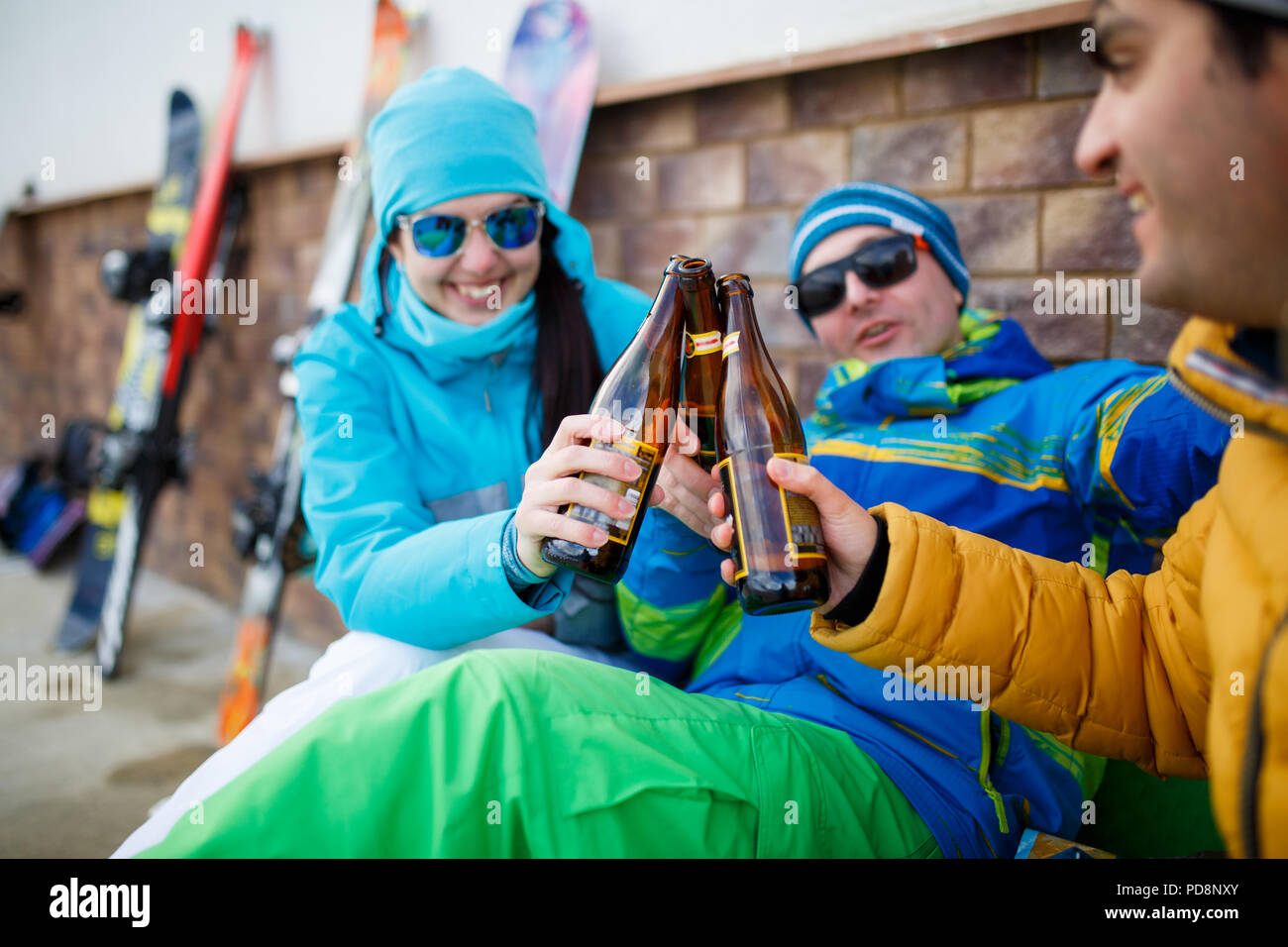 Photo of happy men and women in sunglasses with beer on winter day Stock Photo