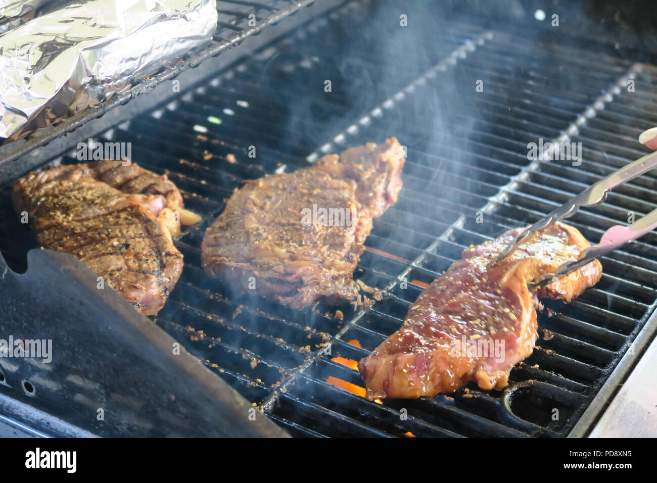 Grilling Steaks on the Patio Deck, USA Stock Photo Alamy