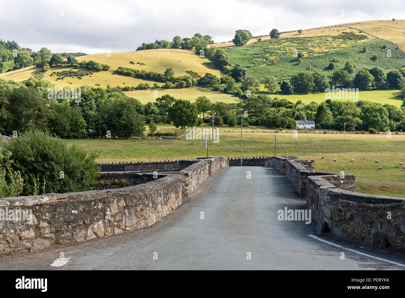 An old stone arched bridge over The River Dee flowing through the Vale