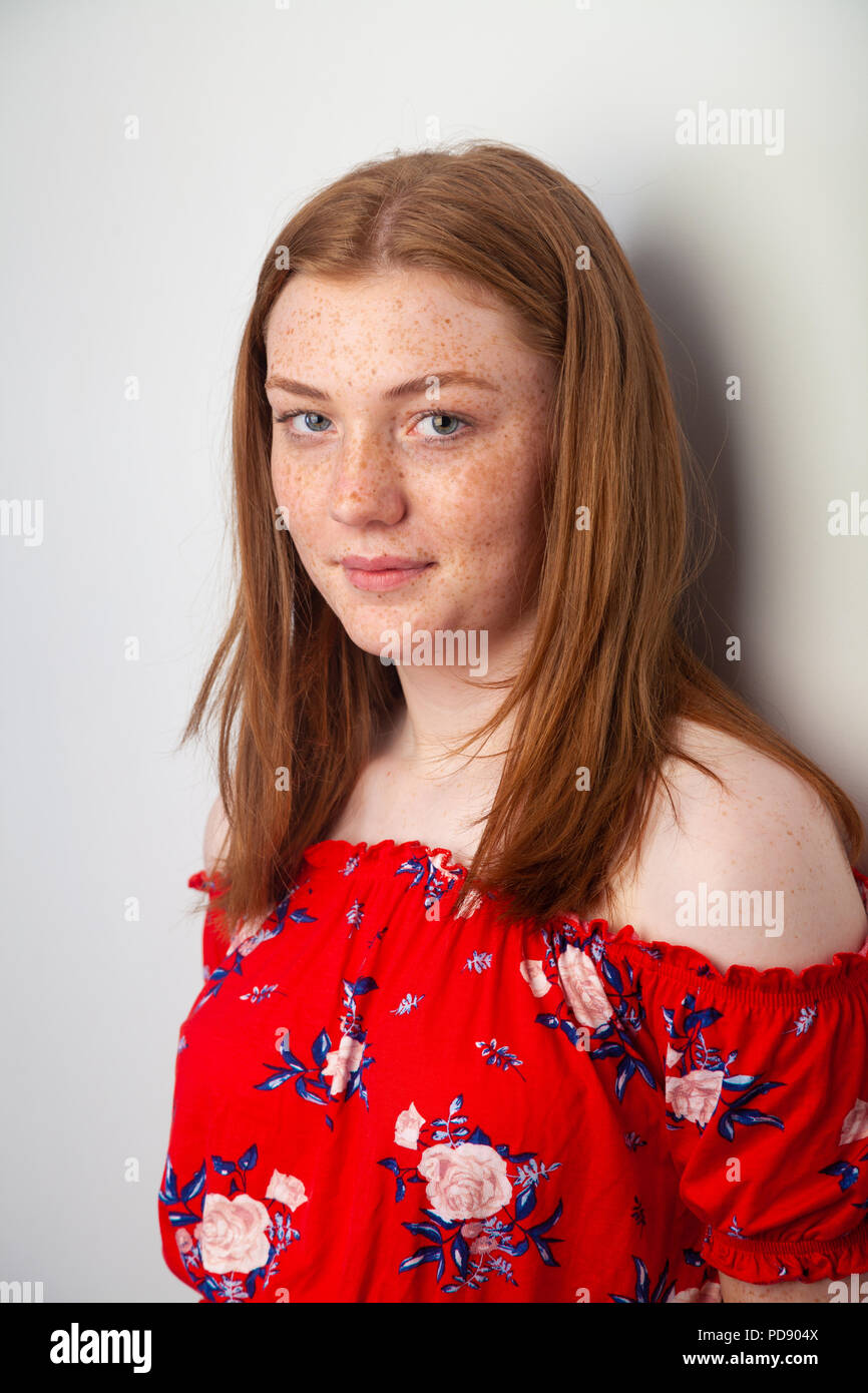 Portrait Of A Pretty Teenage Girl With Red Hair And Freckles