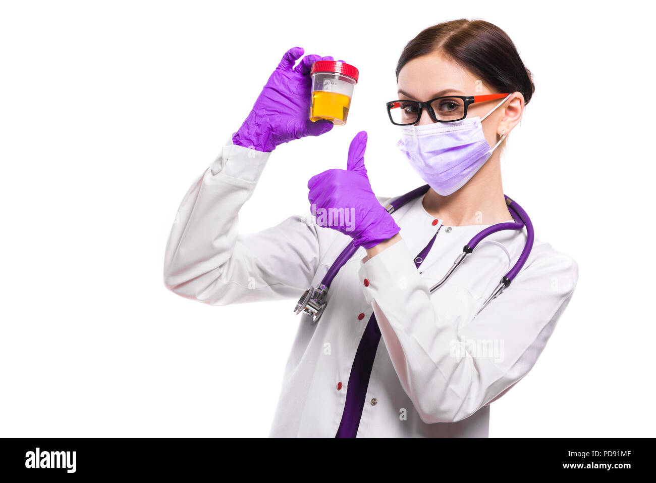Young beautiful female doctor holding urine sample in her hands in ...
