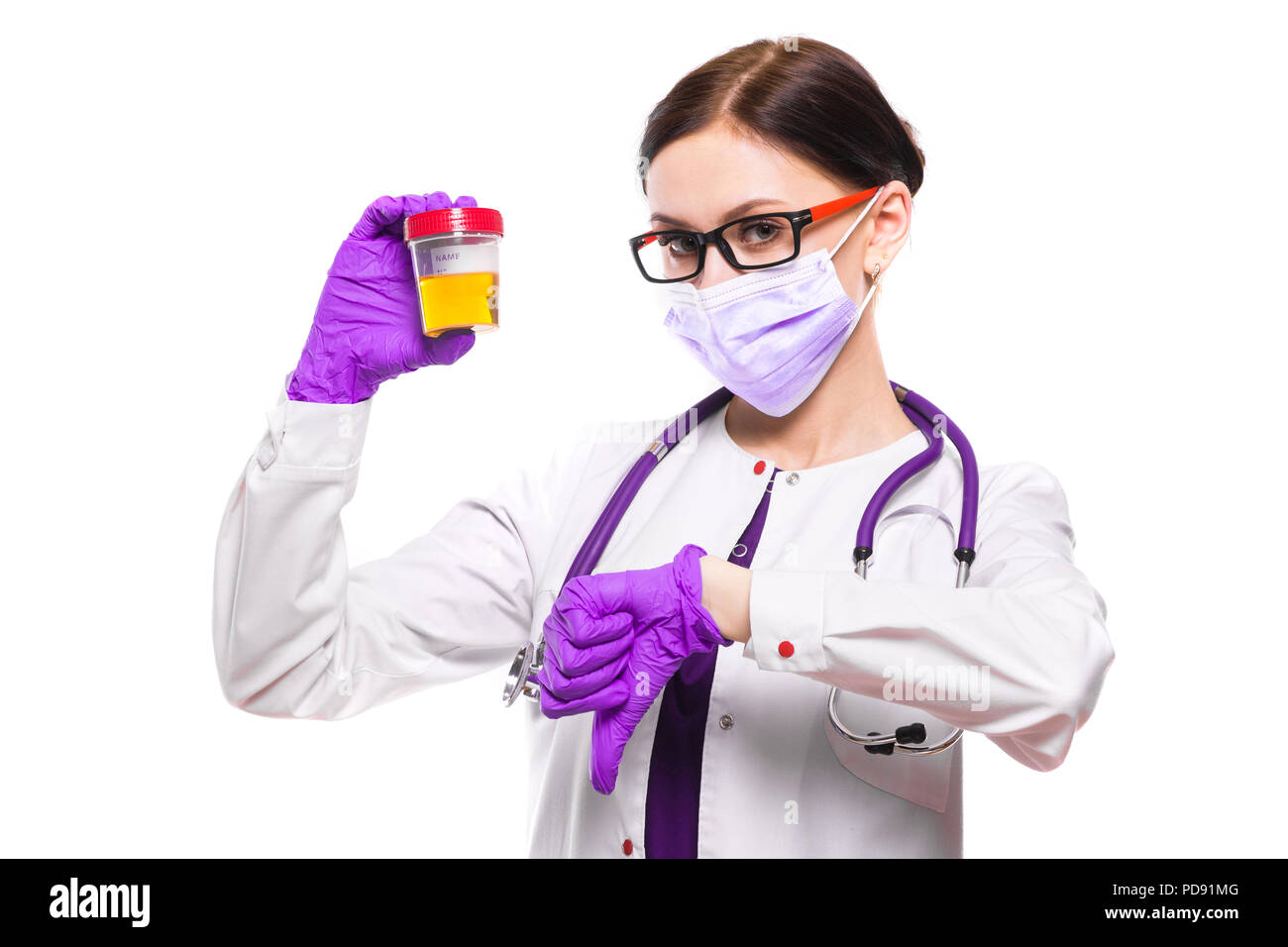 Young beautiful female doctor holding urine sample in her hands in ...