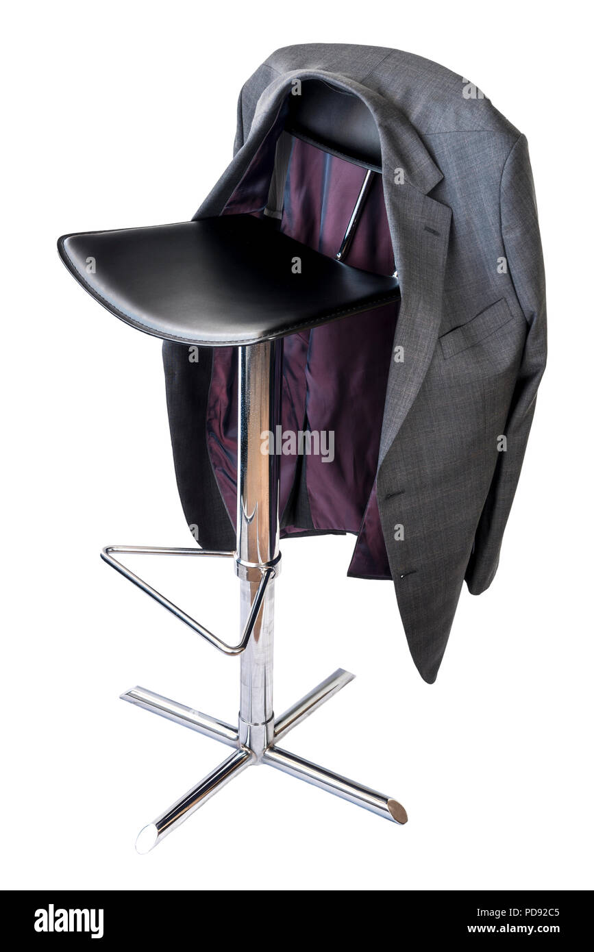 Black leather and chrome bar stool on a white background, with a mans suit jacket hanging on the back. Stock Photo