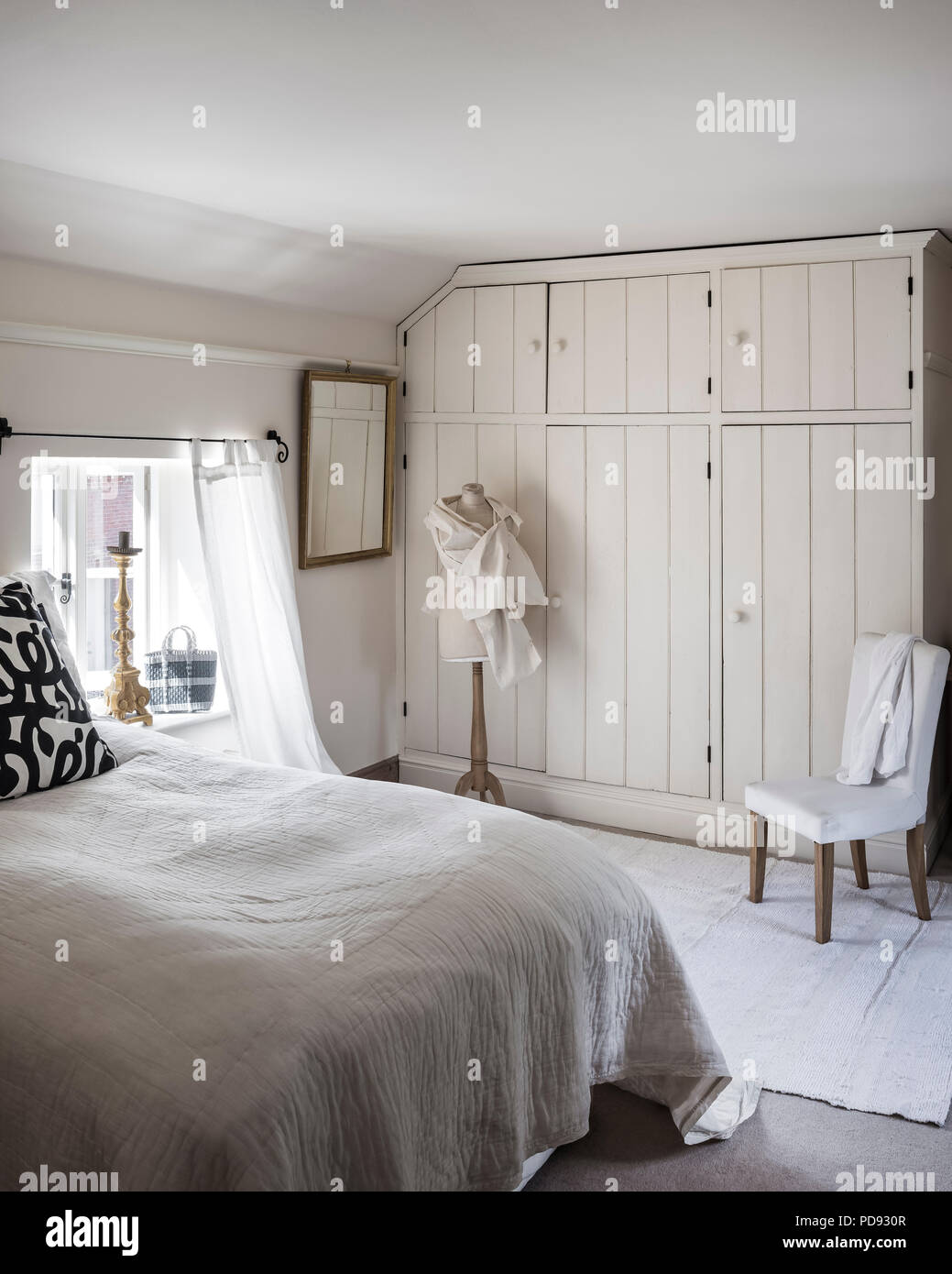 Inbuilt cupboards made of recycled floorboards in light and airy