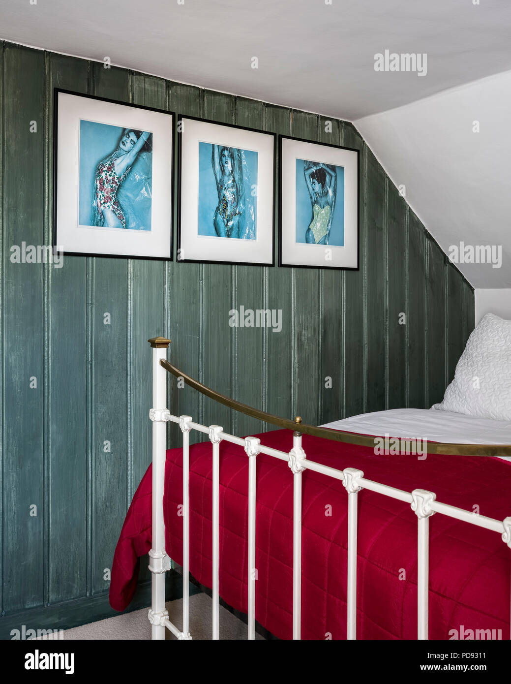 Green panelled attic bedroom with iron bedstead. The photographs were taken by James Wedge. Stock Photo