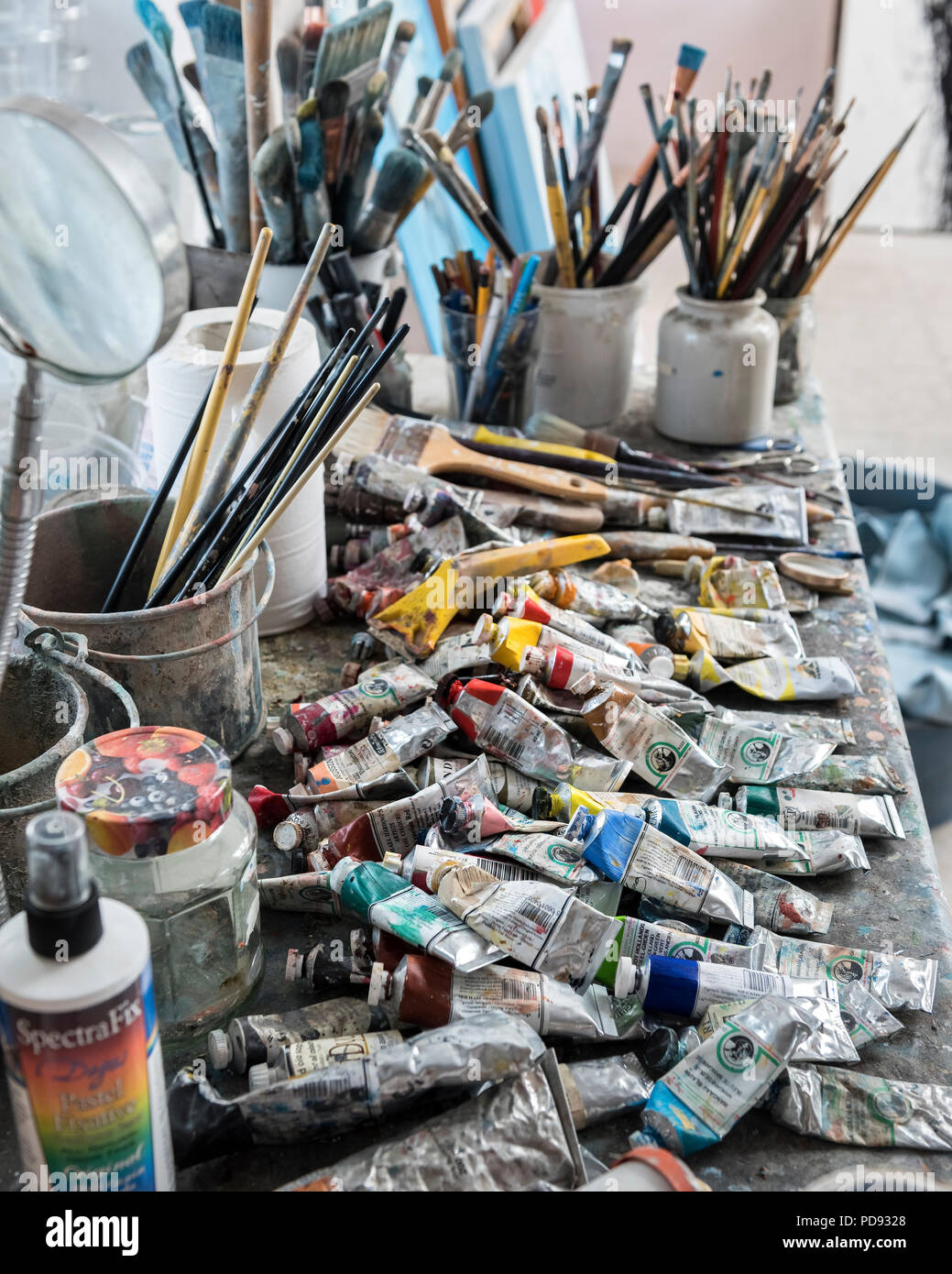 Paint brushes and oil paints in an artist's studio Stock Photo