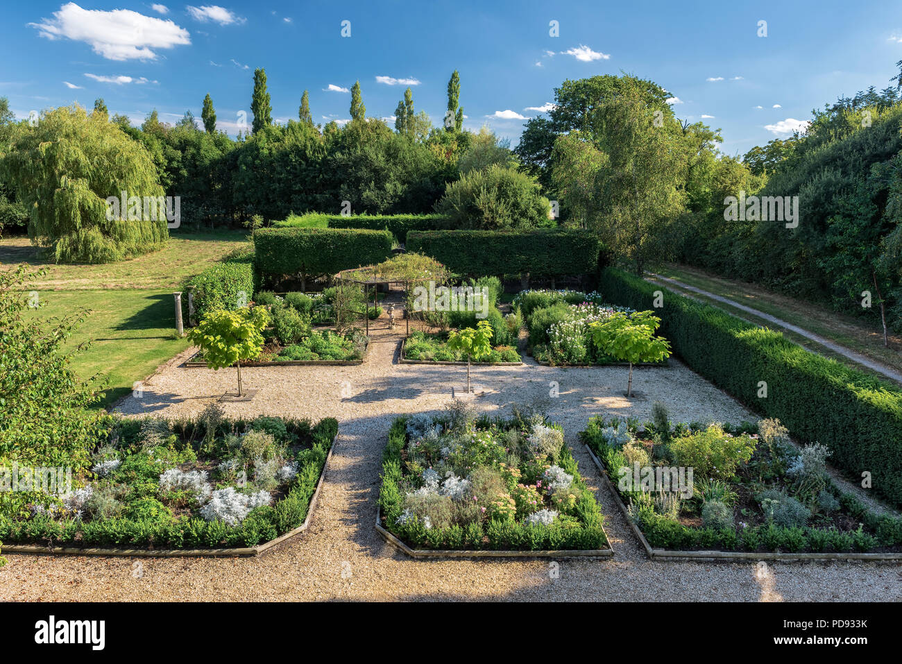 Box-bordered herbaceous beds in english country garden Stock Photo