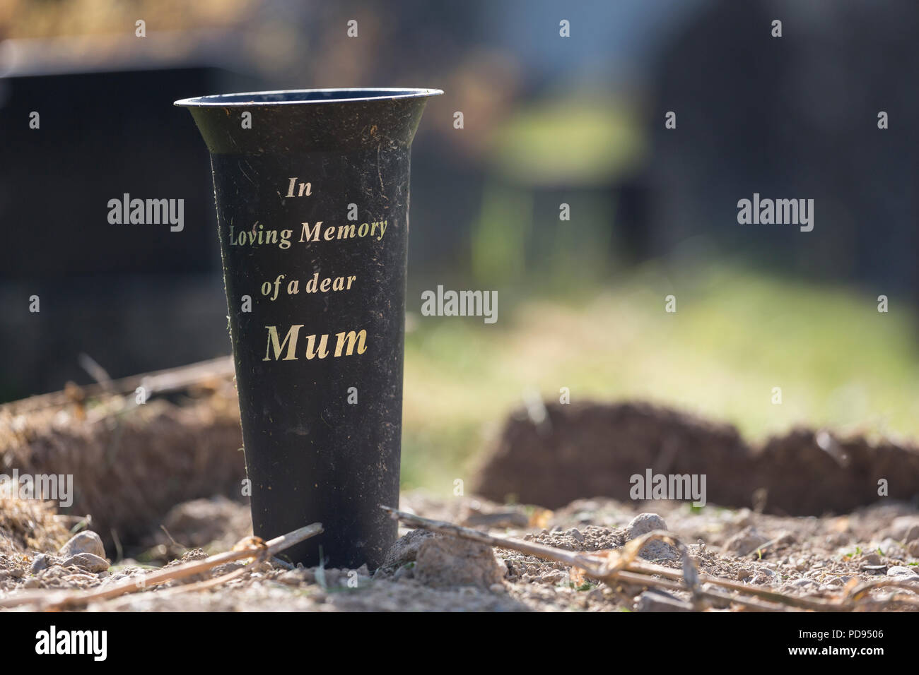 Vase On Bare Dried Up Grave Reads In Loving Memory Of A Dear Mum