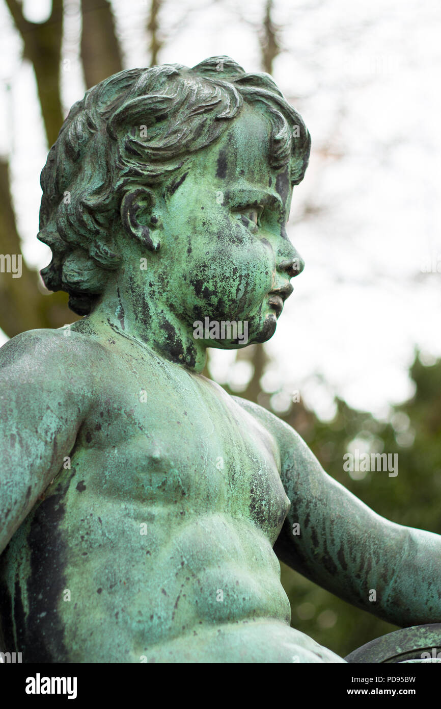 Green copper angel statue religious symbol for piece and love and trinity  Stock Photo - Alamy