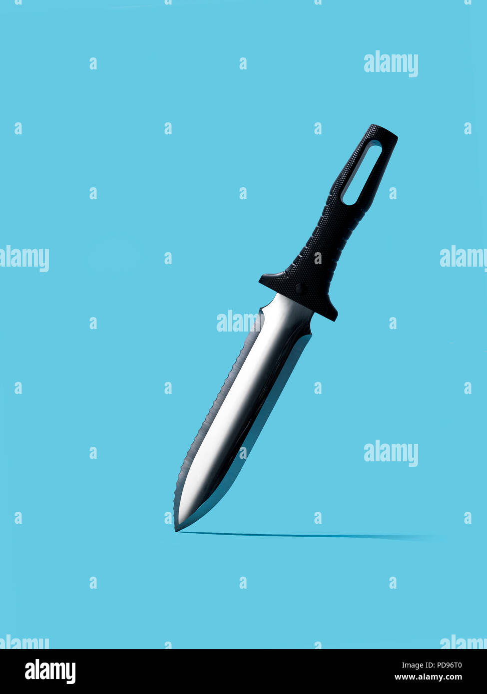 Hunting knife on a blue background Stock Photo