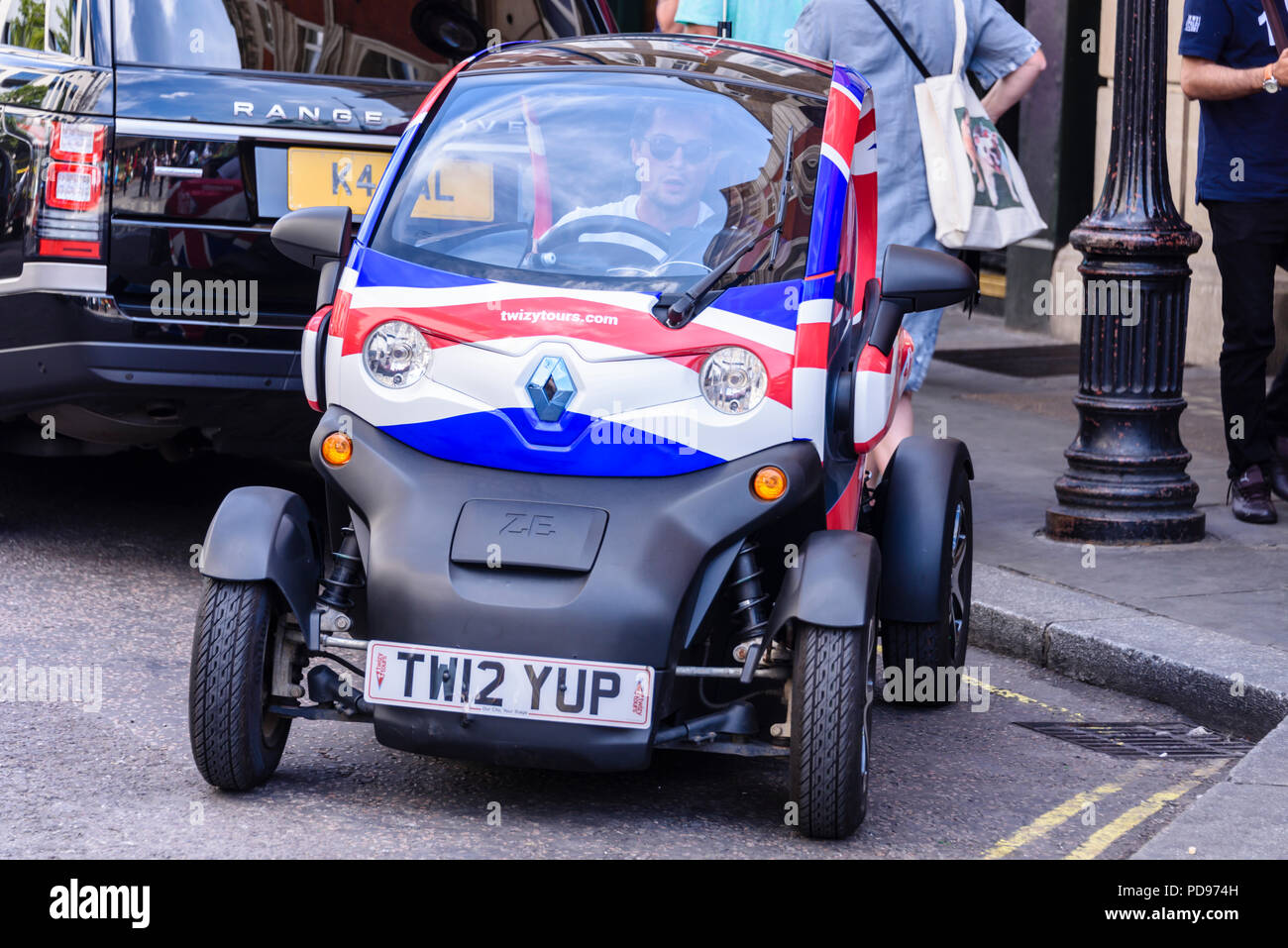 Renault Twizy two seat electric car with Union Jack vinyl wrap used to give tourists a tour around London. Stock Photo