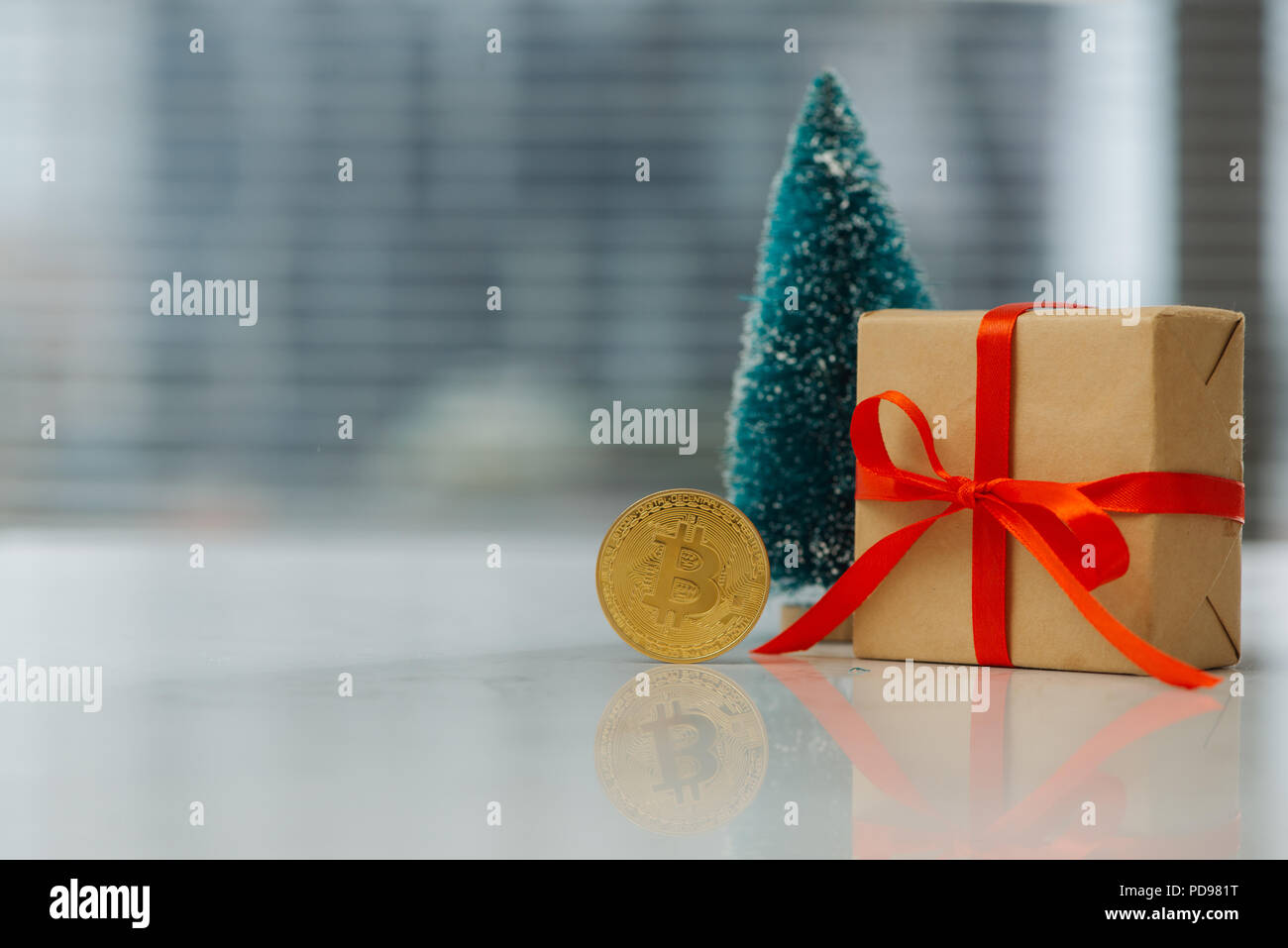 Christmas gift or New Year with ribbon and little fir and best gift bitcoin coin on light background. Cryptocurrency investition concept Stock Photo