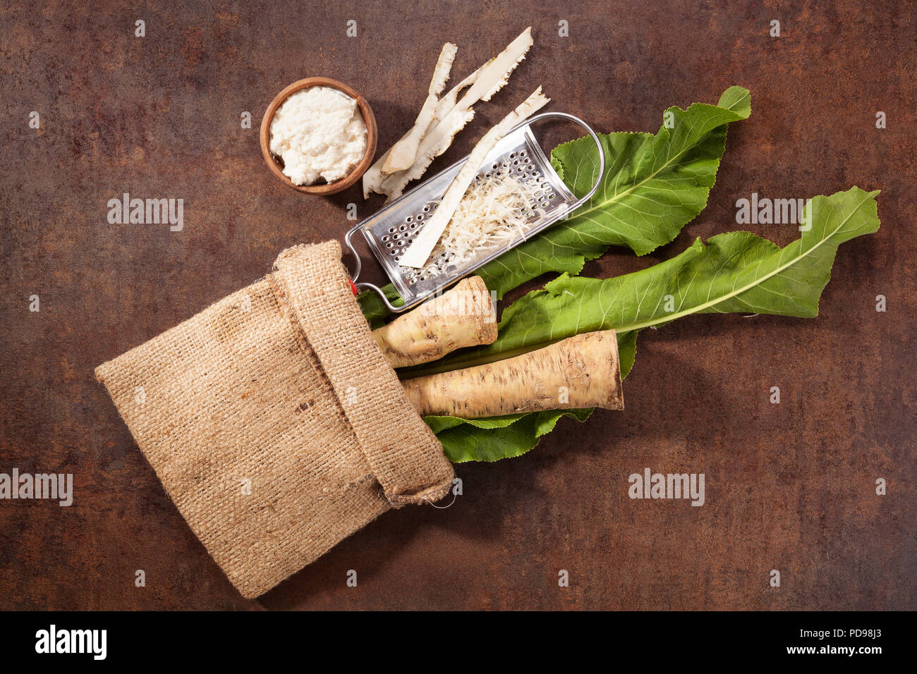 Raw horseradish roots and grated horseradish with leaf on grunge