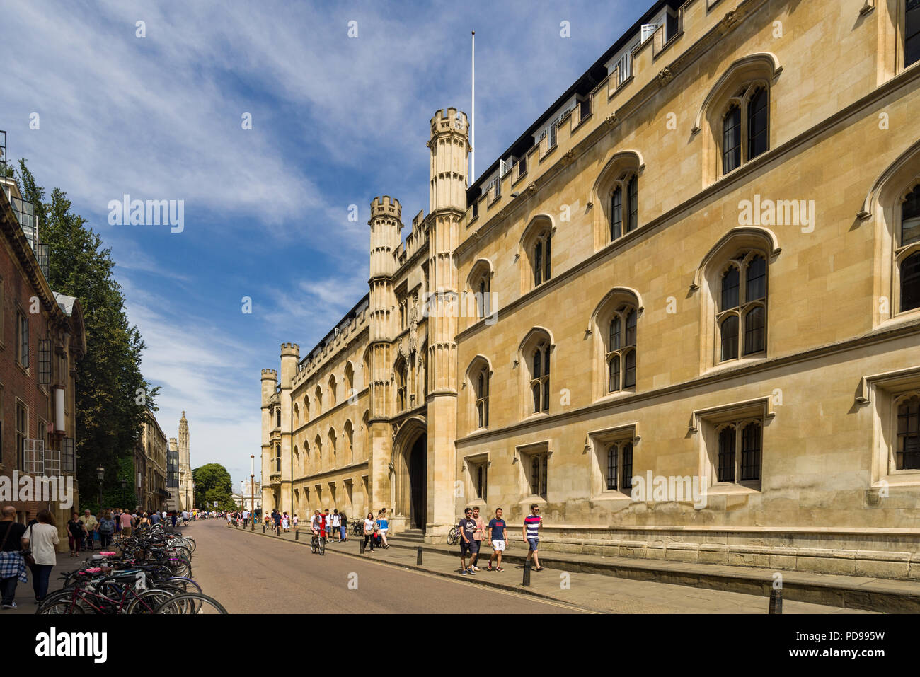 Exterior of Corpus Christi College from Trumpington Street with people walking on pavement outside, Cambridge, UK Stock Photo