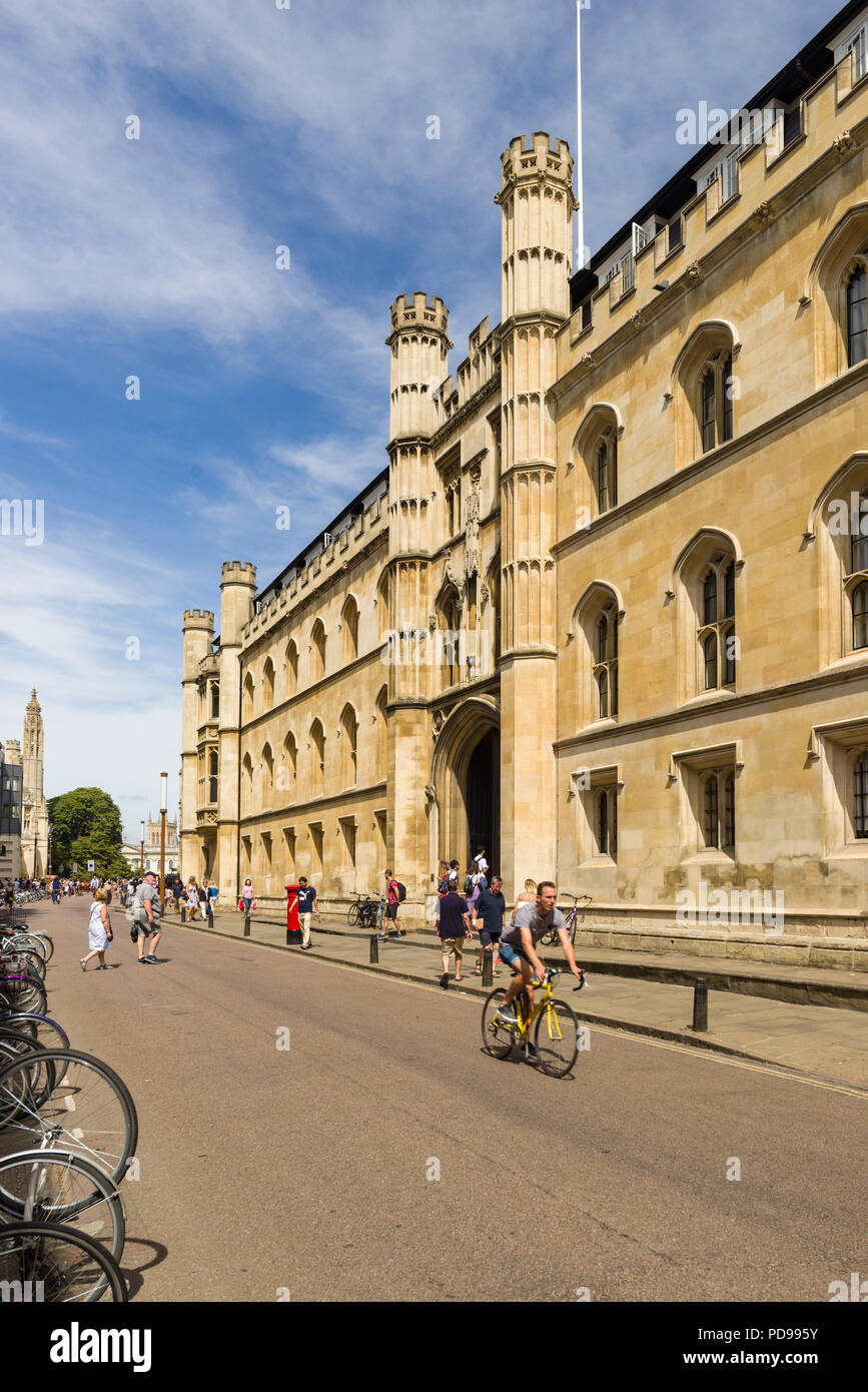 Exterior of Corpus Christi College from Trumpington Street with people walking on pavement outside, Cambridge, UK Stock Photo