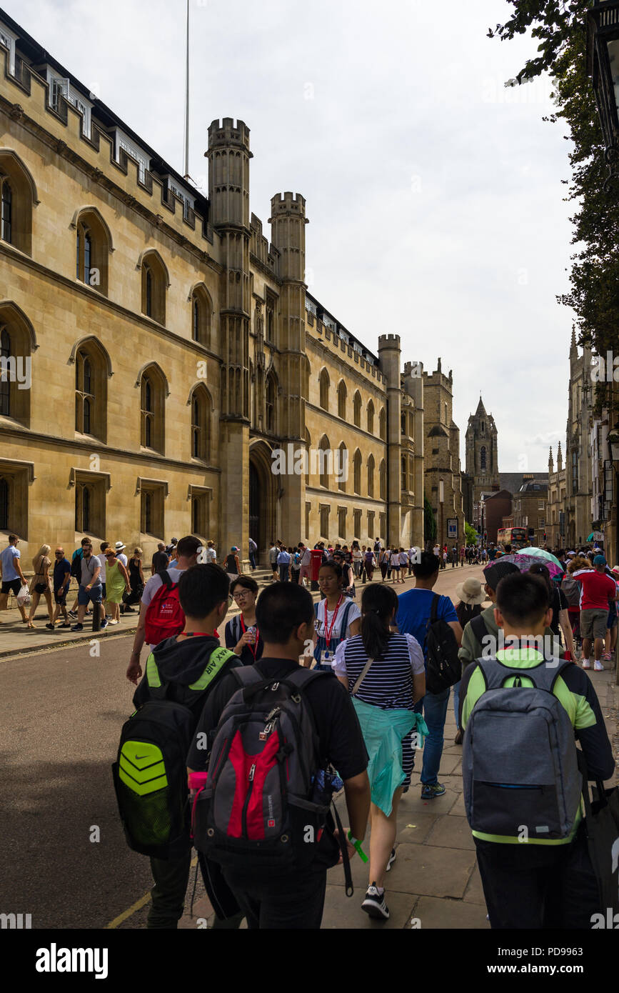 Exterior of Corpus Christi College from Trumpington Street with people walking on pavement outside, Cambridge, UK Stock Photo