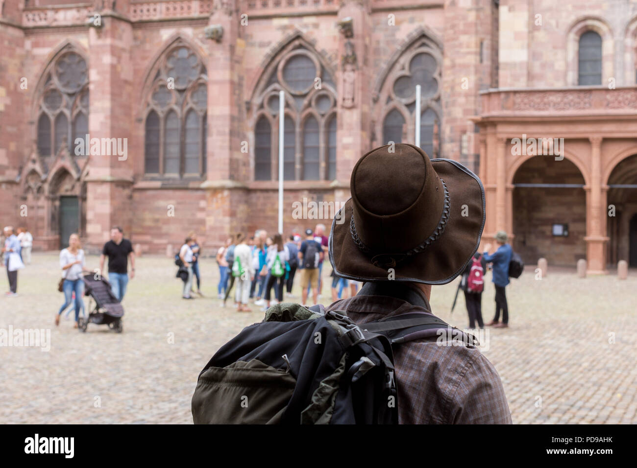 A tourist looking at European gothic cathedral Freibirg Minster in Germany Stock Photo