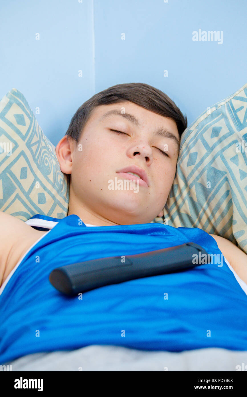 Teenage boy sleeping on his bed hires stock photography and images Alamy