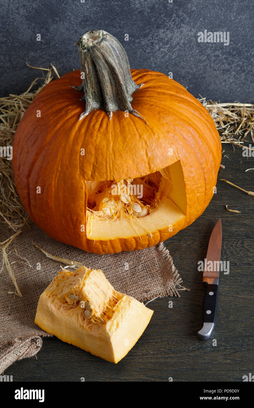 Carving halloween pumpkin into jack-o-lantern, close up view Stock Photo