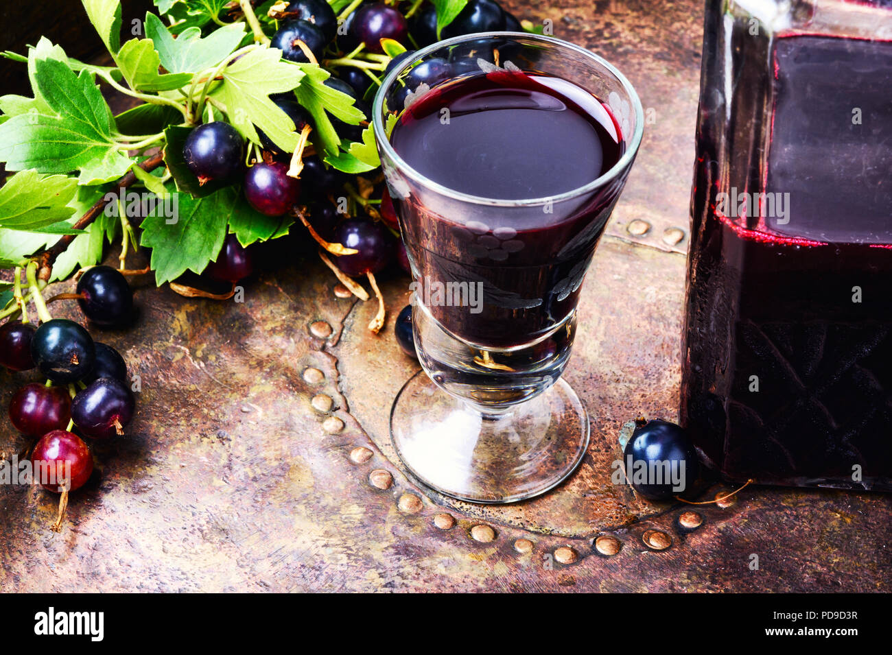 Glass with homemade liqueur from black currant Stock Photo - Alamy