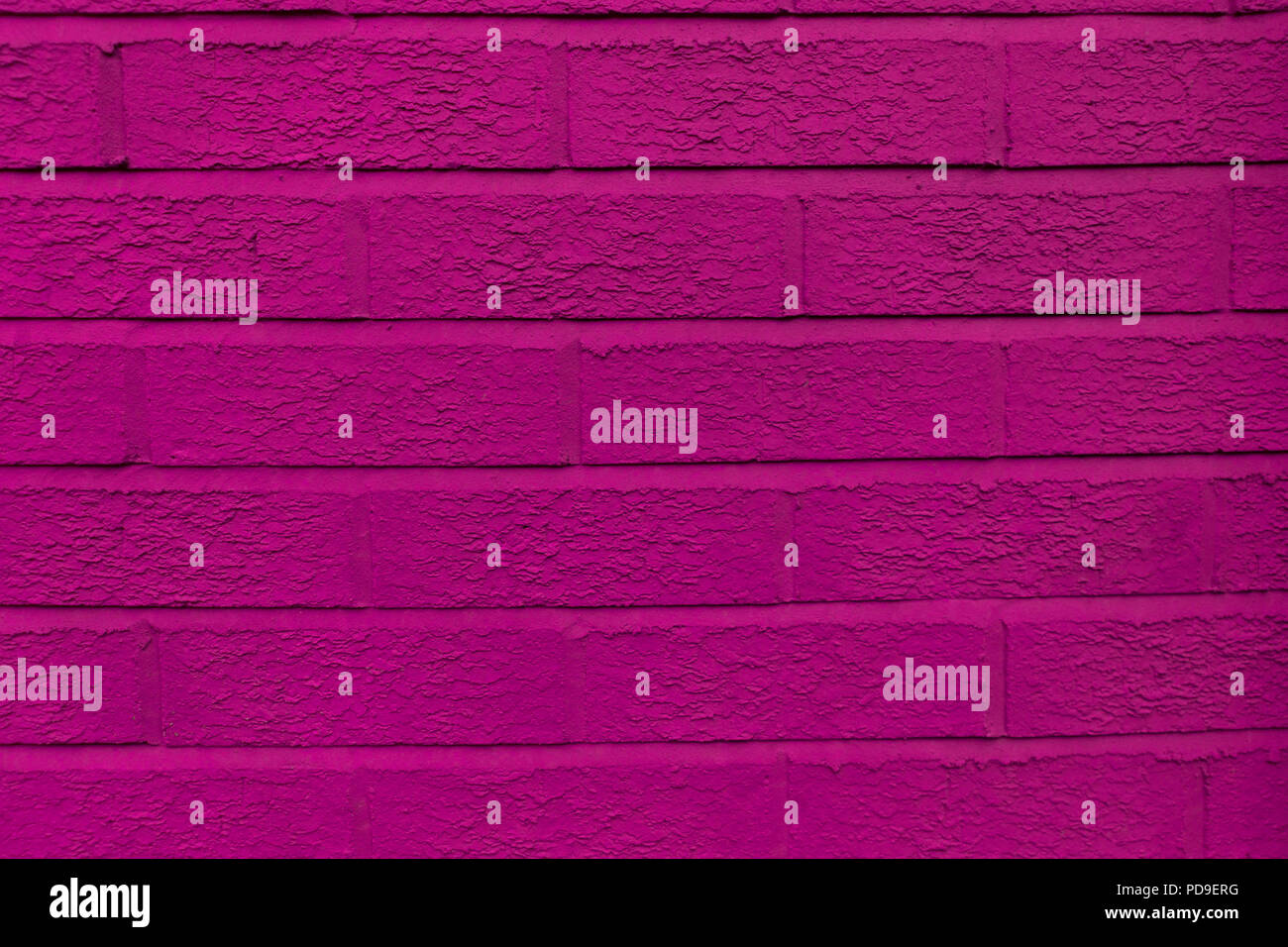 Close-up of the pink, amaranth, fuchsia, purple, ultra violet painted wall brick background Stock Photo