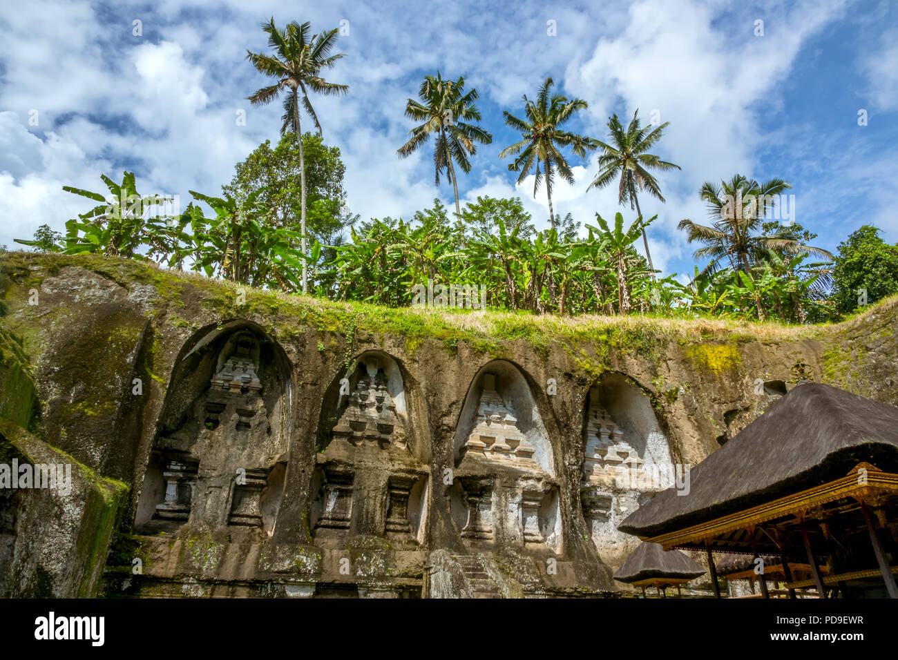 Indonesia. Bali island. Temple carved into the rock, thatched roofs and ...
