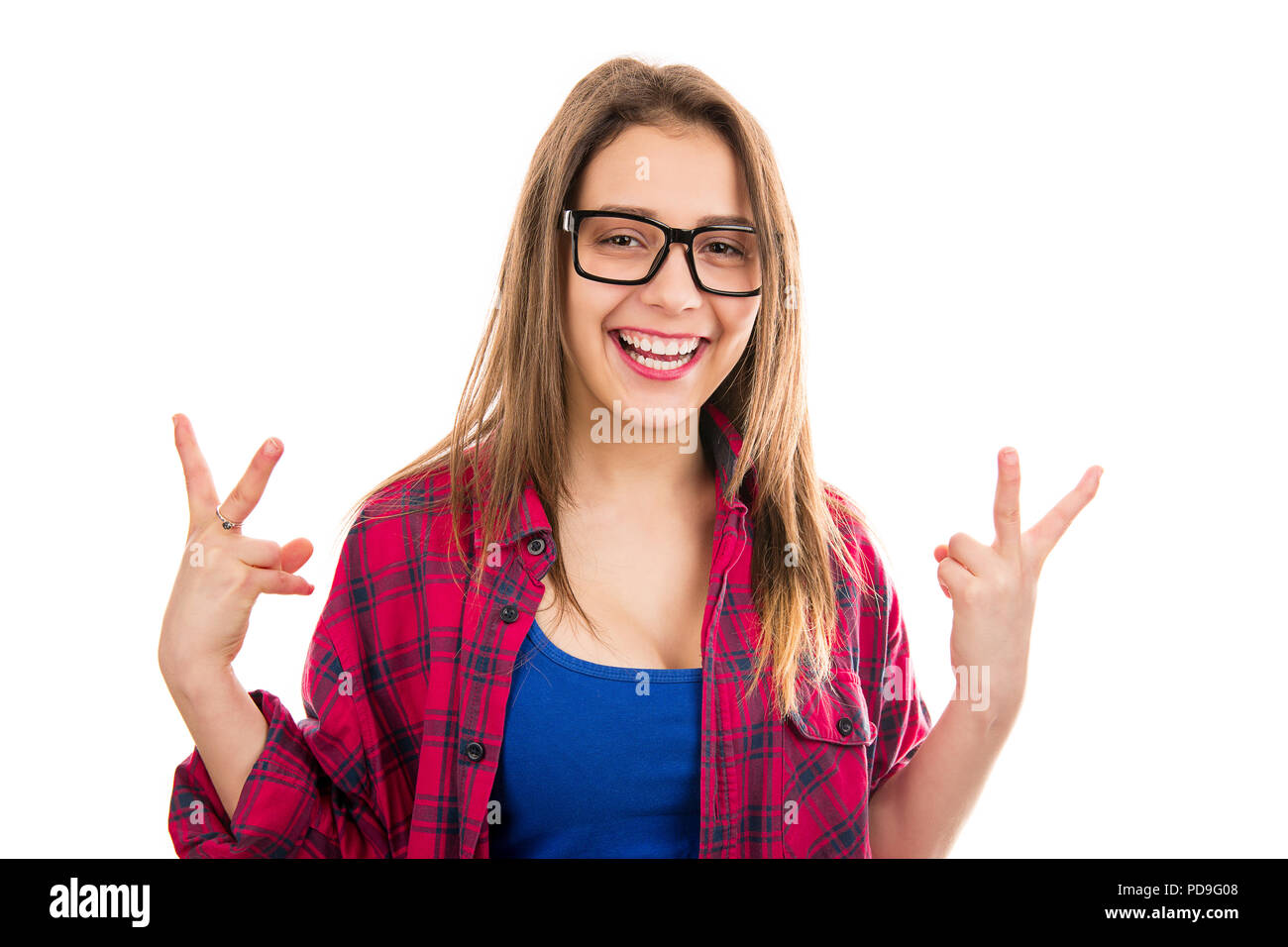 Young cute excited woman in glasses holding cool gesture sign celebrating victory on white background. Stock Photo